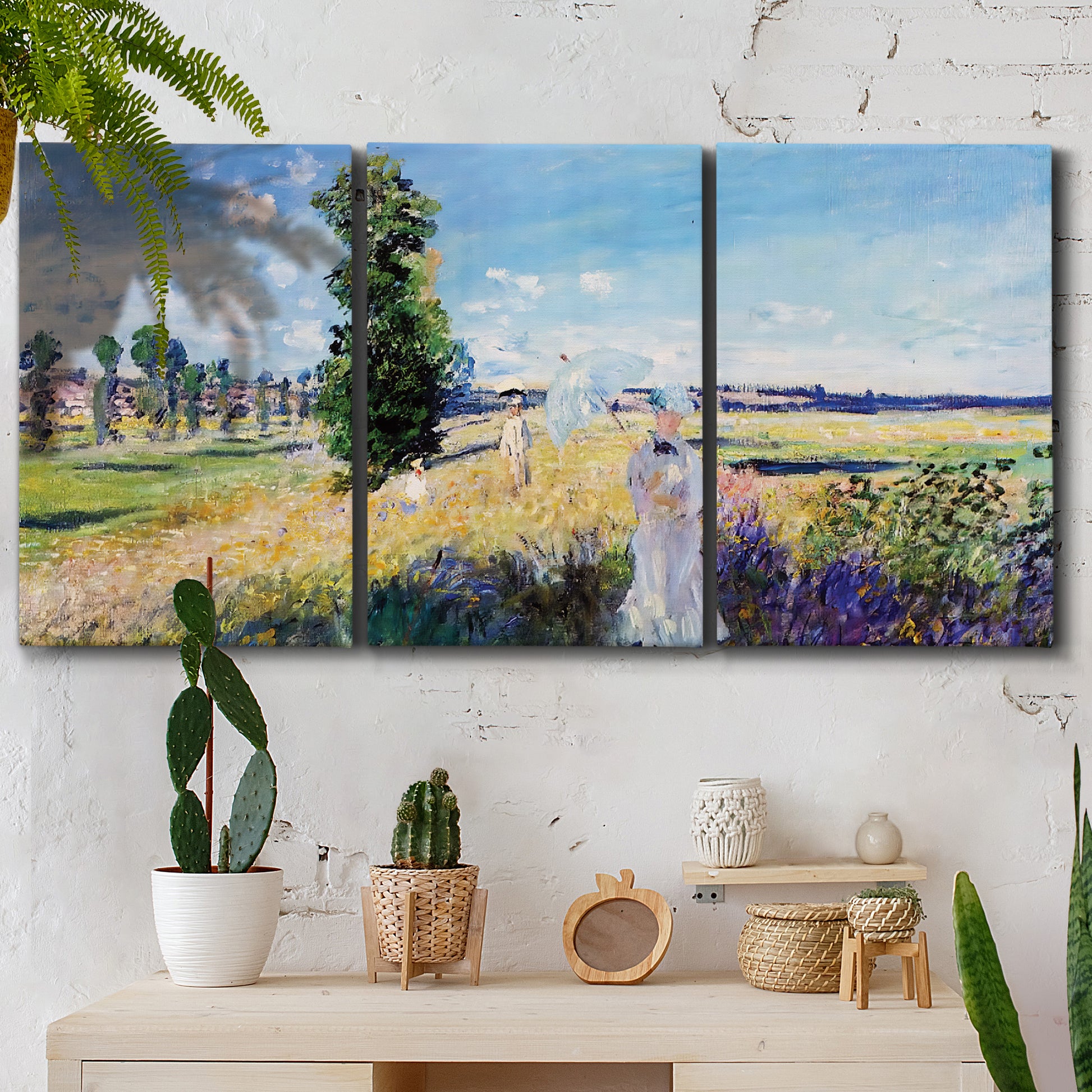 Three-panel canvas wall art featuring riverside path with figures, displayed in a boho-chic entryway above a console table.