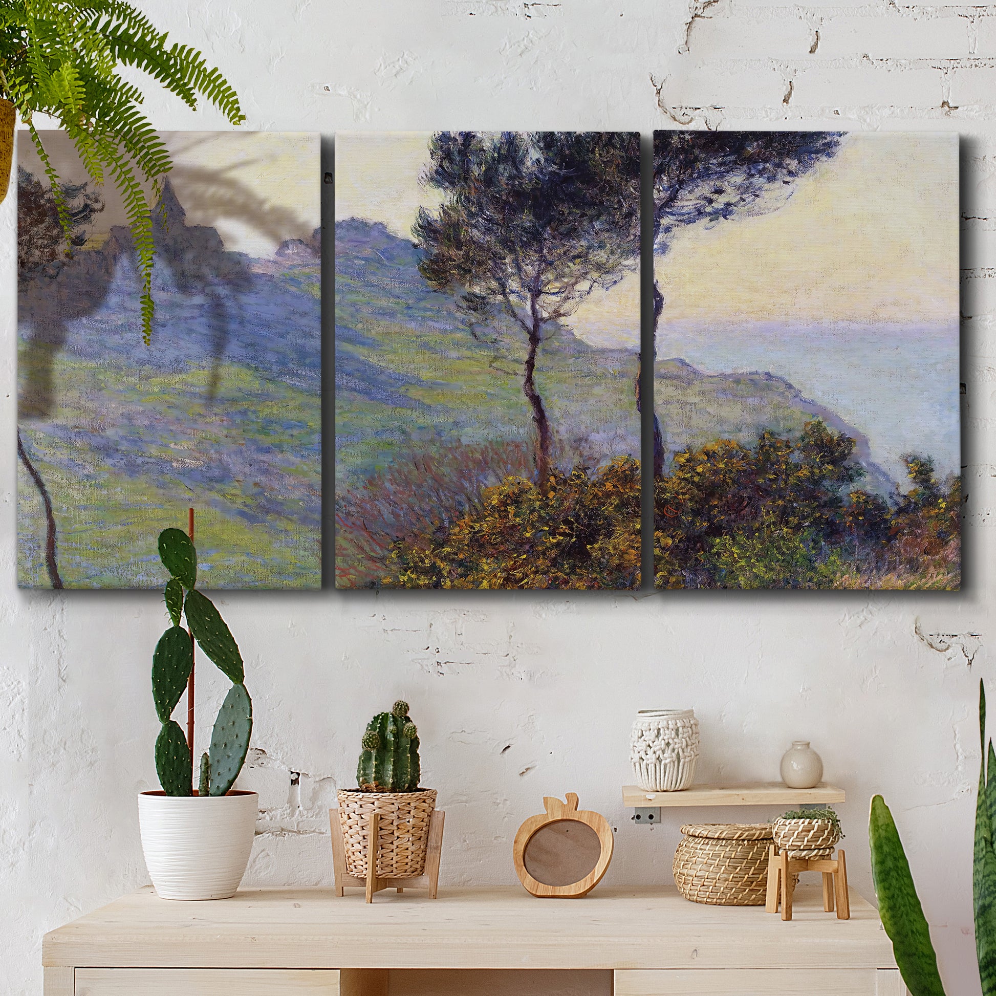 Three-panel canvas wall art featuring village church at sunset, displayed in a boho-chic entryway above a console table.