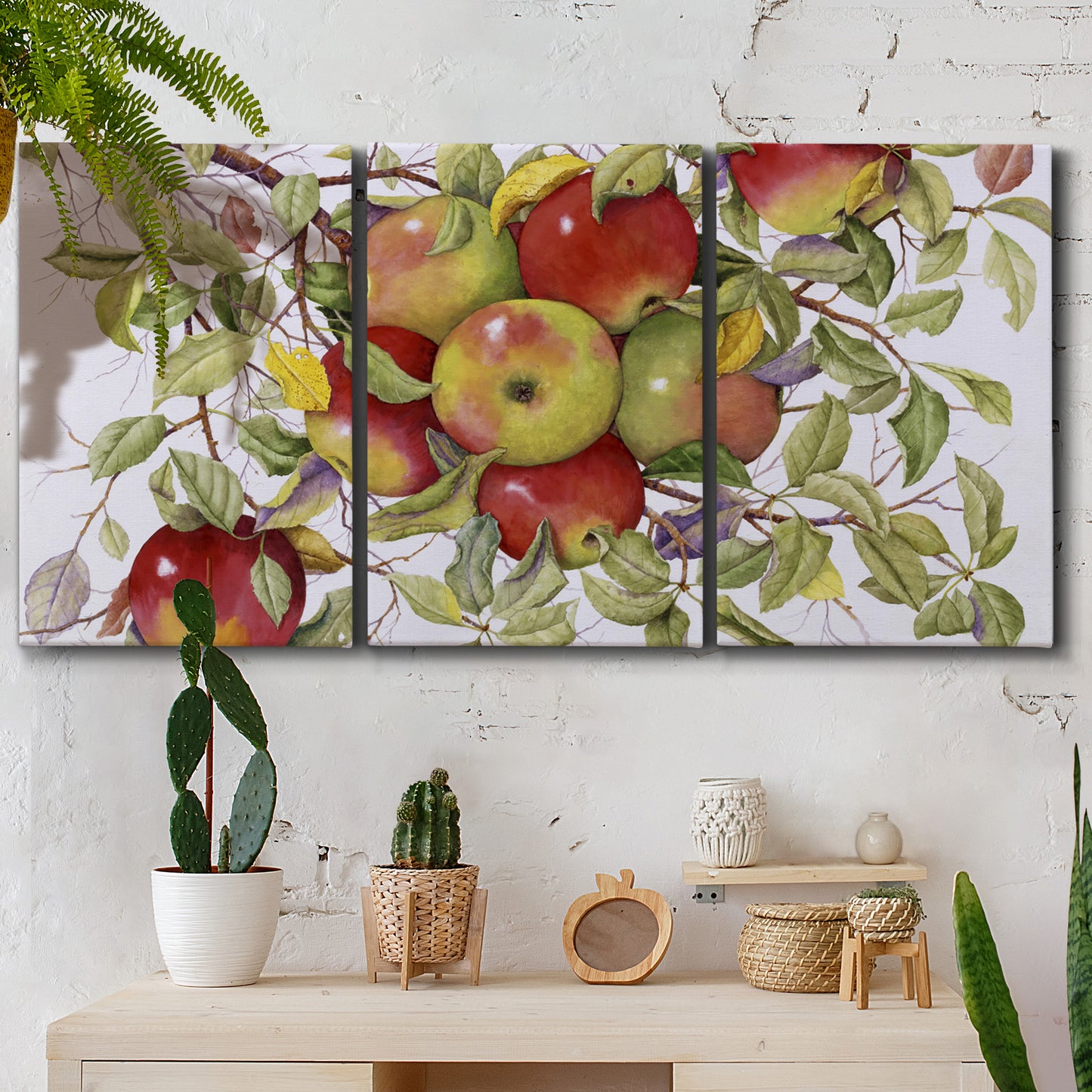 Three-panel canvas wall art featuring apples hanging from branch, displayed in a boho-chic entryway above a console table.