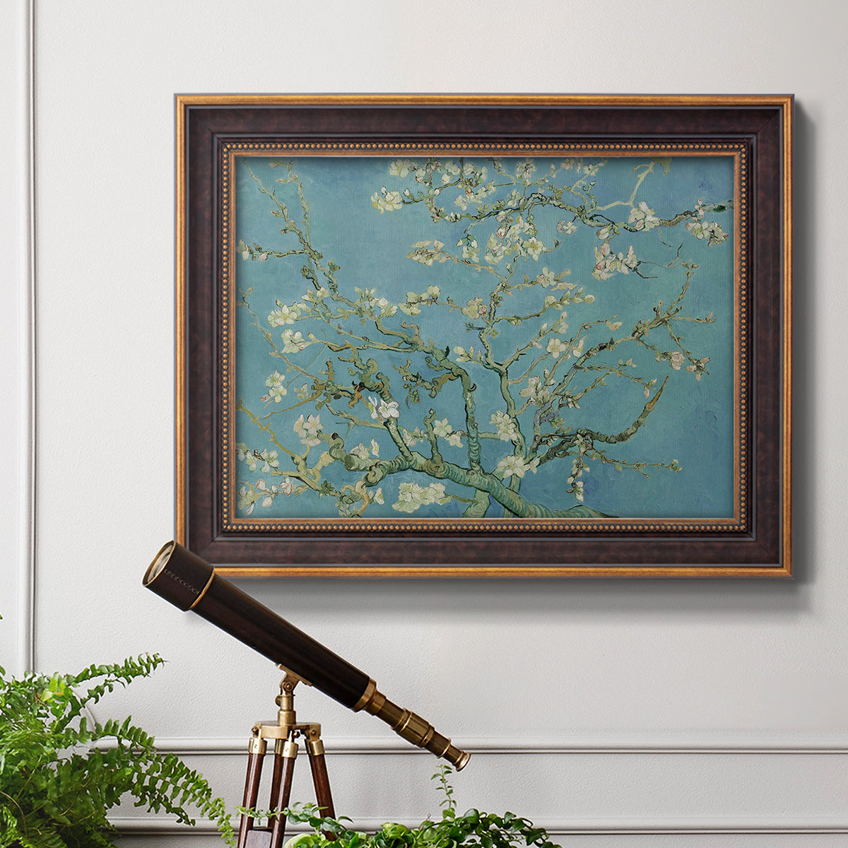 Impressionist flowering almond branch painting by Vincent van Gogh in an ornate bronzed mahogany wood frame displayed in a light-toned interior setting.