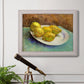 Impressionist still life with lemons by Vincent van Gogh in an ornate weathered white frame displayed in a light-toned interior setting.