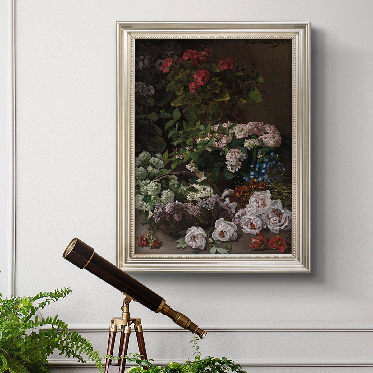 Early impressionist floral painting by Claude Monet in an ornate champagne frame displayed in a light-toned interior setting.
