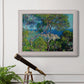Impressionist Mediterranean coastal landscape by Claude Monet in an ornate weathered white frame displayed in a light-toned interior setting.