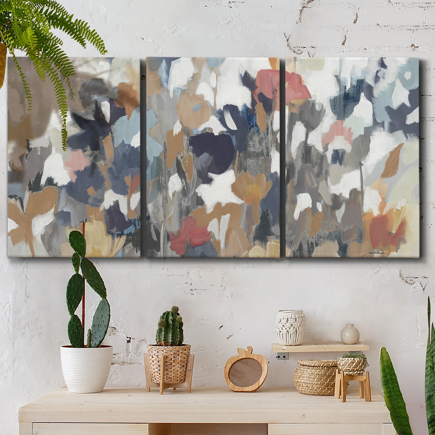 Three-panel canvas wall art featuring abstract flower stand composition, displayed in a boho-chic entryway above a console table.