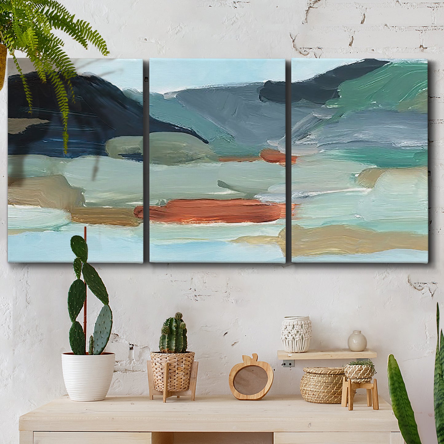 Three-panel canvas wall art featuring vibrant abstract with dramatic motion, displayed in a boho-chic entryway above a console table.