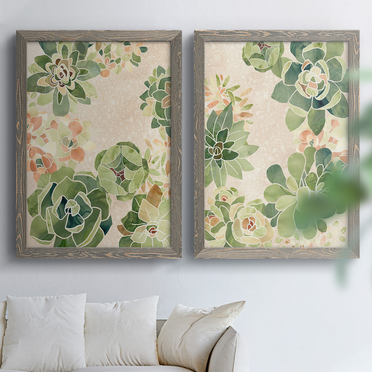 Set of two gray barnwood framed canvas prints depicting green rosettes, peach blossoms, and mosaic-like outlines arranged across two complementary compositions above a sofa in a bright living space.