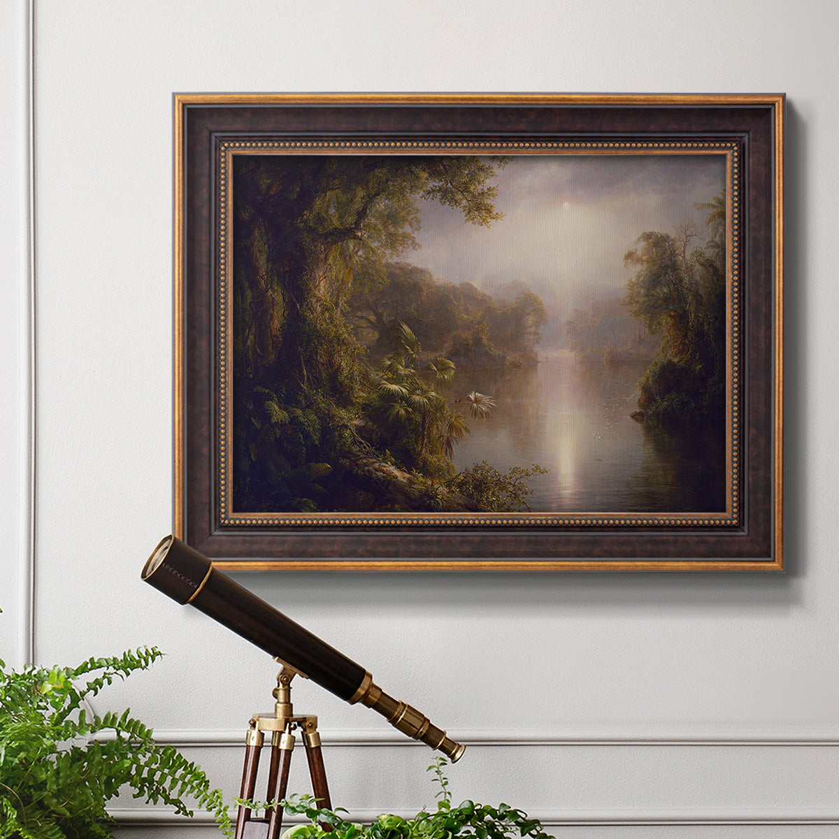 Luminous romantic landscape painting by Frederic Edwin Church in an ornate bronzed mahogany wood frame displayed in a light-toned interior setting.