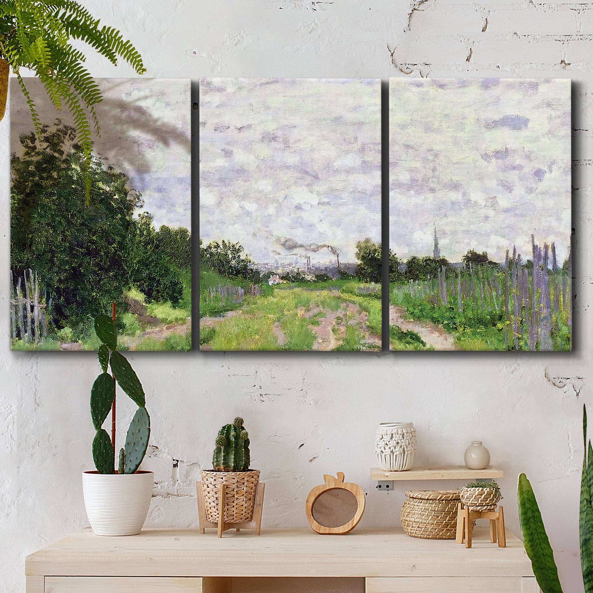 Three-panel canvas wall art featuring spring landscape with blossoming trees, displayed in a boho-chic entryway above a console table.