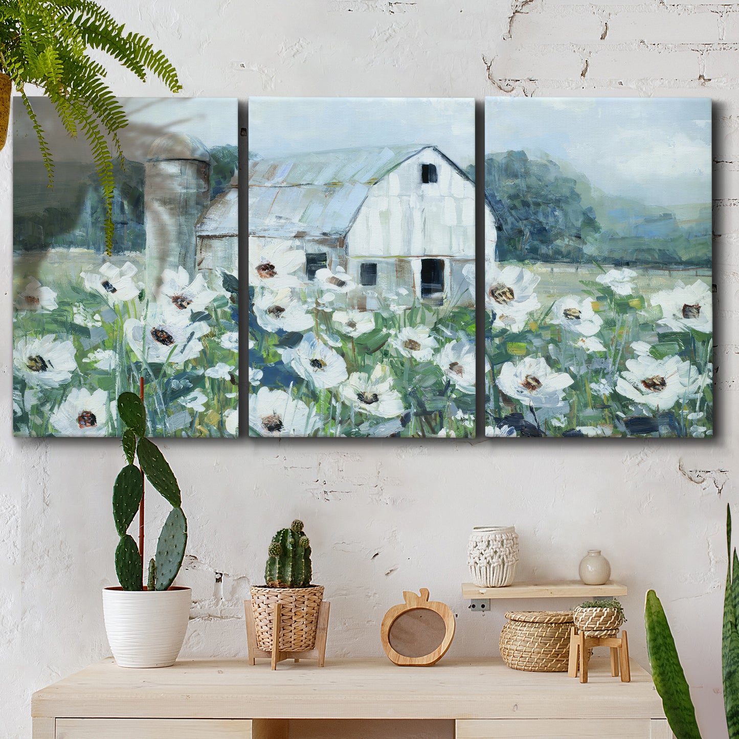 Three-panel canvas wall art featuring pastoral farmland with open fields, displayed in a boho-chic entryway above a console table.