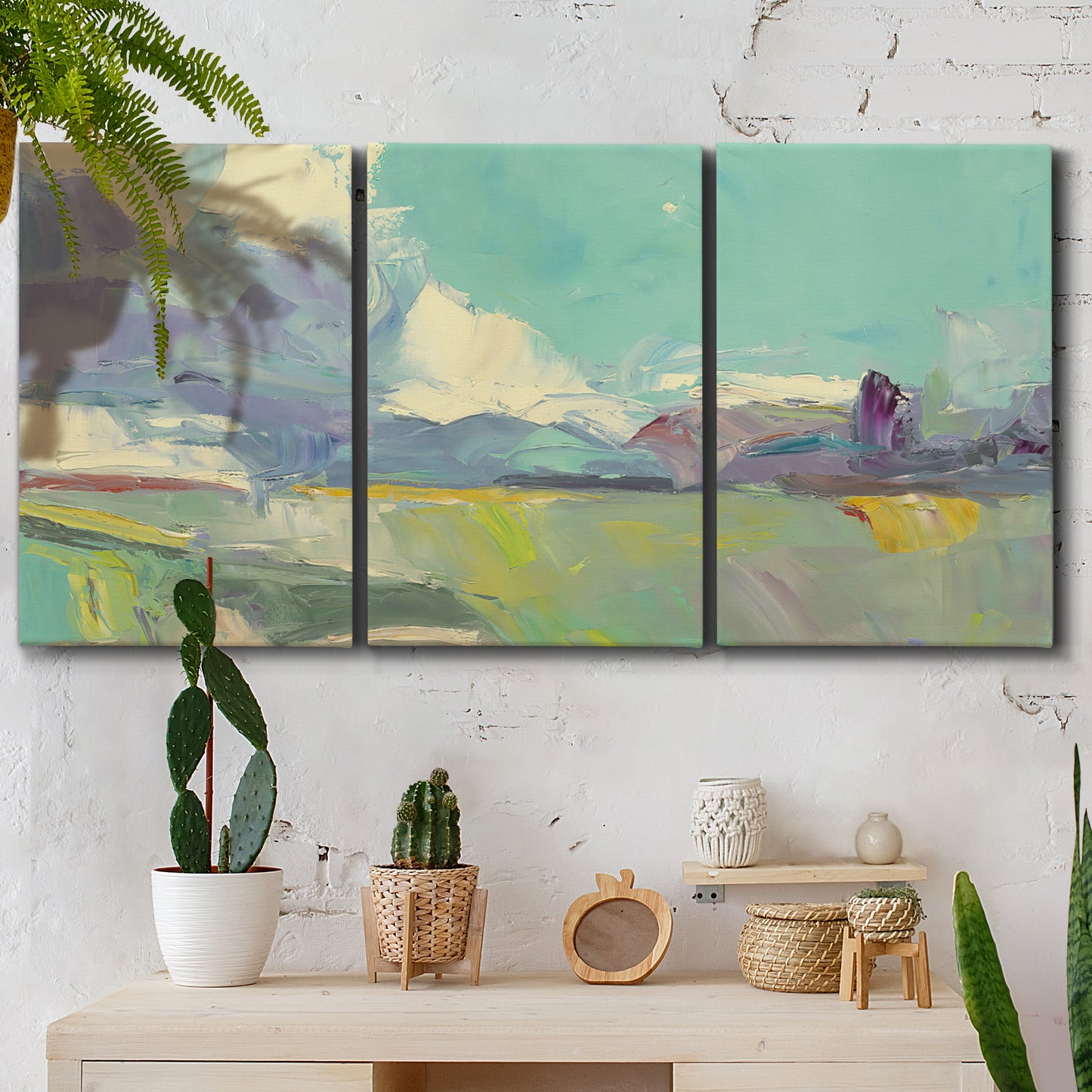 Three-panel canvas wall art featuring road stretching through open countryside, displayed in a boho-chic entryway above a console table.