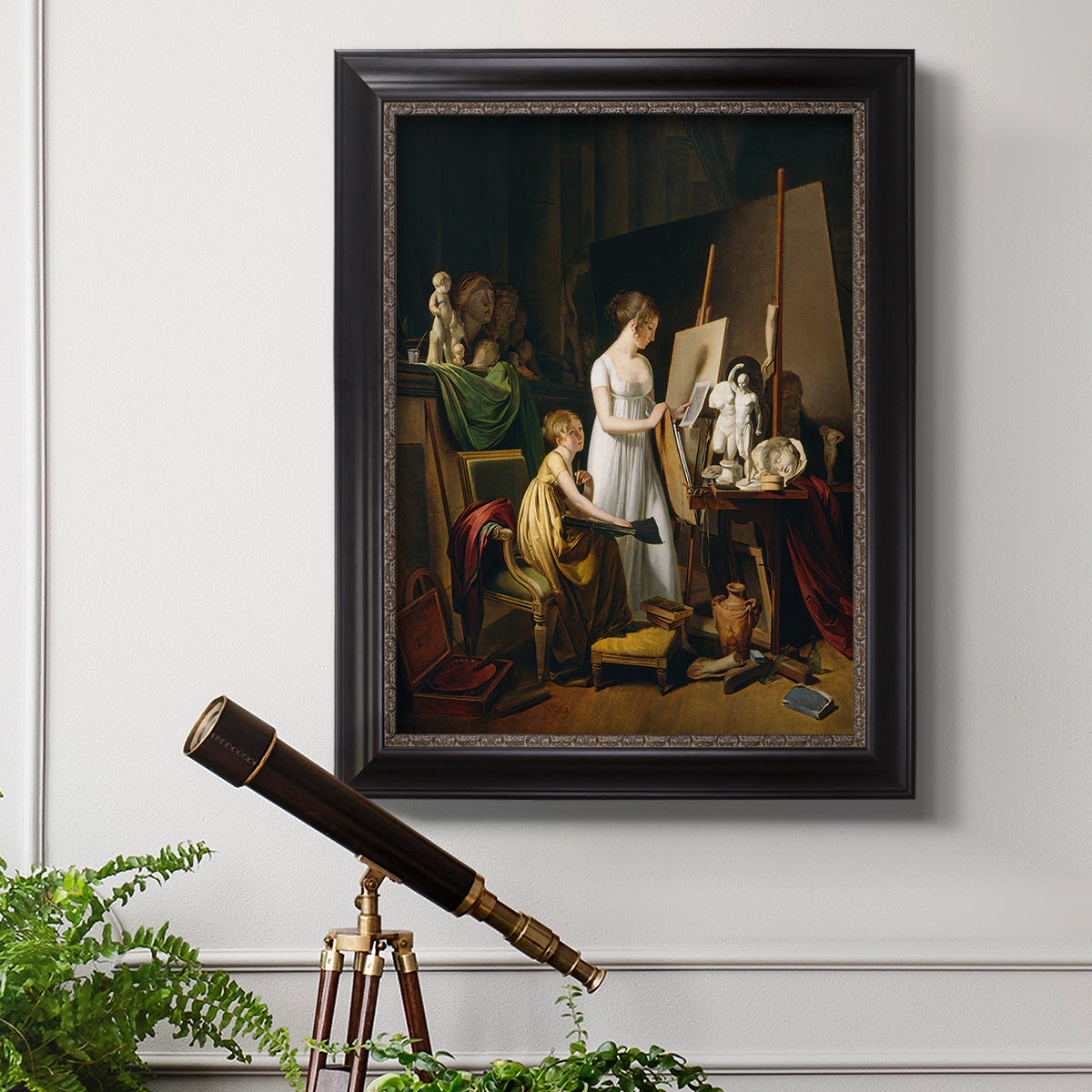 Classical interior painting of an artist at work by Louis-Leopold Boilly in an ornate black frame with gilded inner detail displayed in a light-toned interior setting.