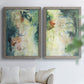 Set of two gray barnwood framed canvas prints depicting vertical organic marks, pale light passages, and weathered surfaces arranged across two complementary compositions above a sofa in a bright living space.