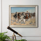 Impressionist western action scene by Frederic Remington in an ornate champagne frame displayed in a light-toned interior setting.