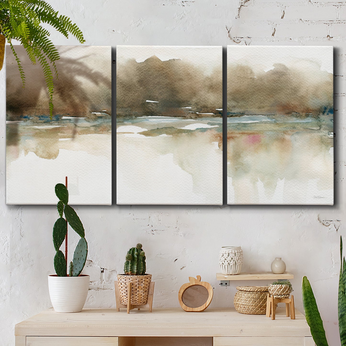 Three-panel canvas wall art featuring soft abstract mirrored reflections, displayed in a boho-chic entryway above a console table.