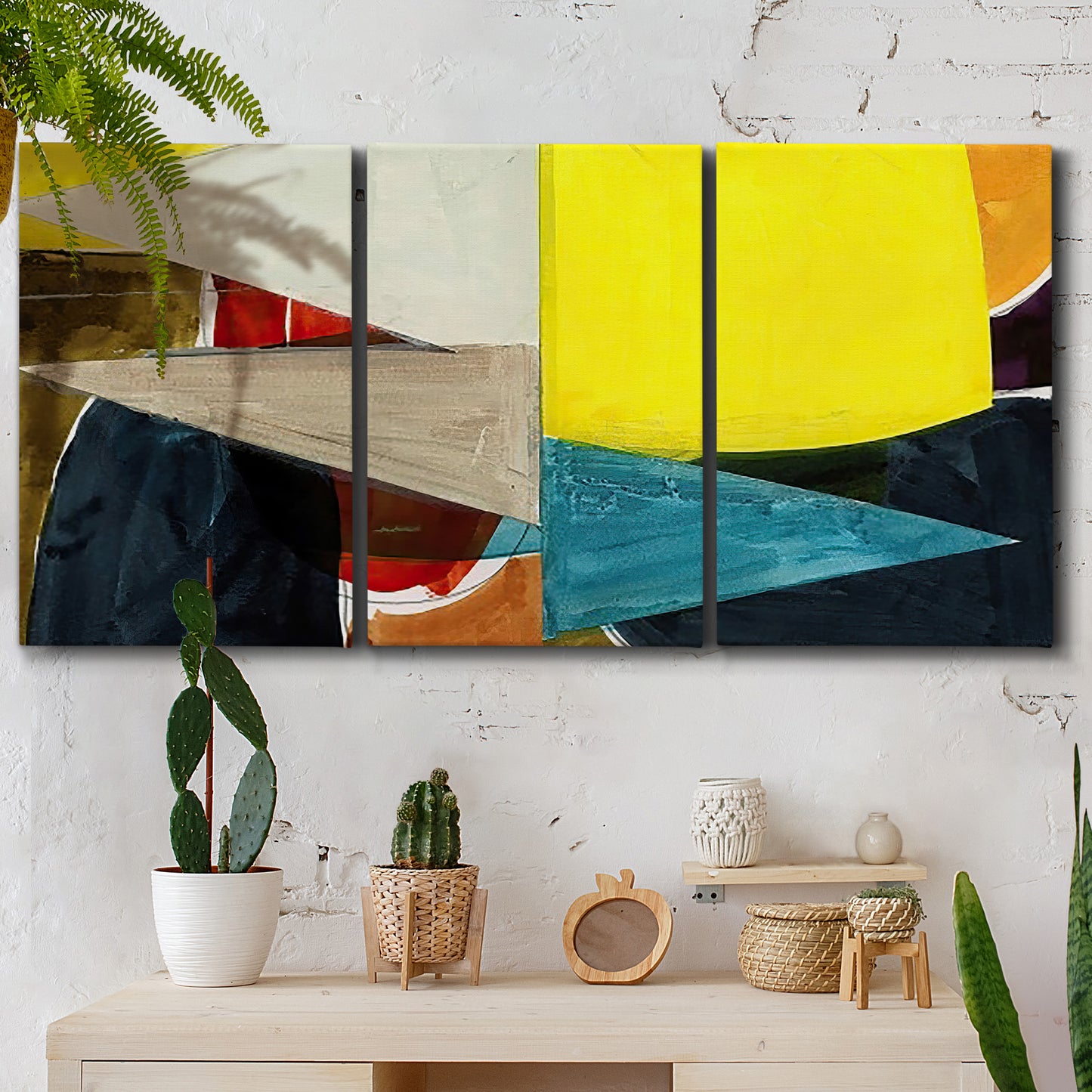 Three-panel canvas wall art featuring geometric mid century abstract blocks, displayed in a boho-chic entryway above a console table.
