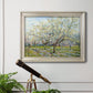 Impressionist white-blossomed orchard landscape by Vincent van Gogh in an ornate champagne frame displayed in a light-toned interior setting.