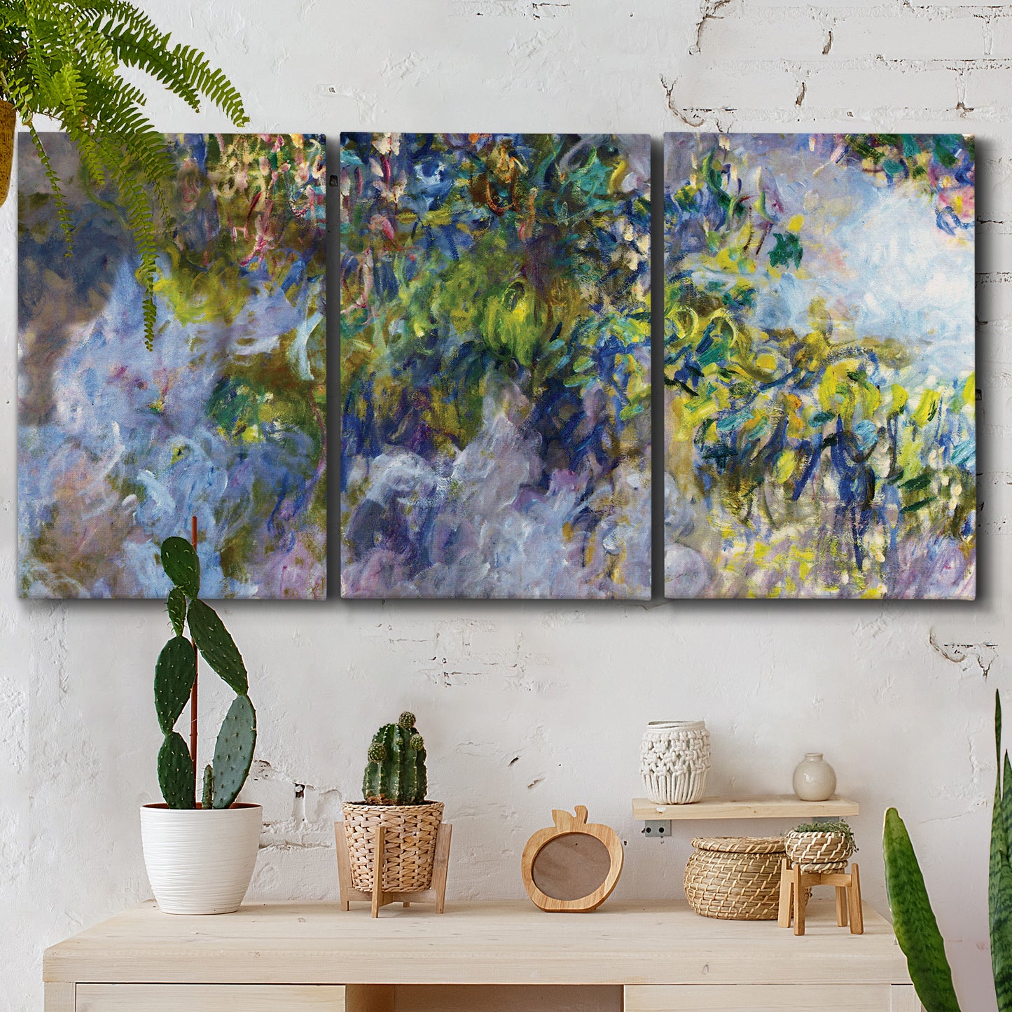 Three-panel canvas wall art featuring cascading purple wisteria blooms, displayed in a boho-chic entryway above a console table.