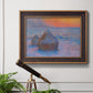 Impressionist haystack scene at sunset by Claude Monet in an ornate bronzed mahogany wood frame displayed in a light-toned interior setting.