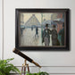 Impressionist urban street scene in the rain by Gustave Caillebotte in an ornate black frame with gilded inner detail displayed in a light-toned interior setting.