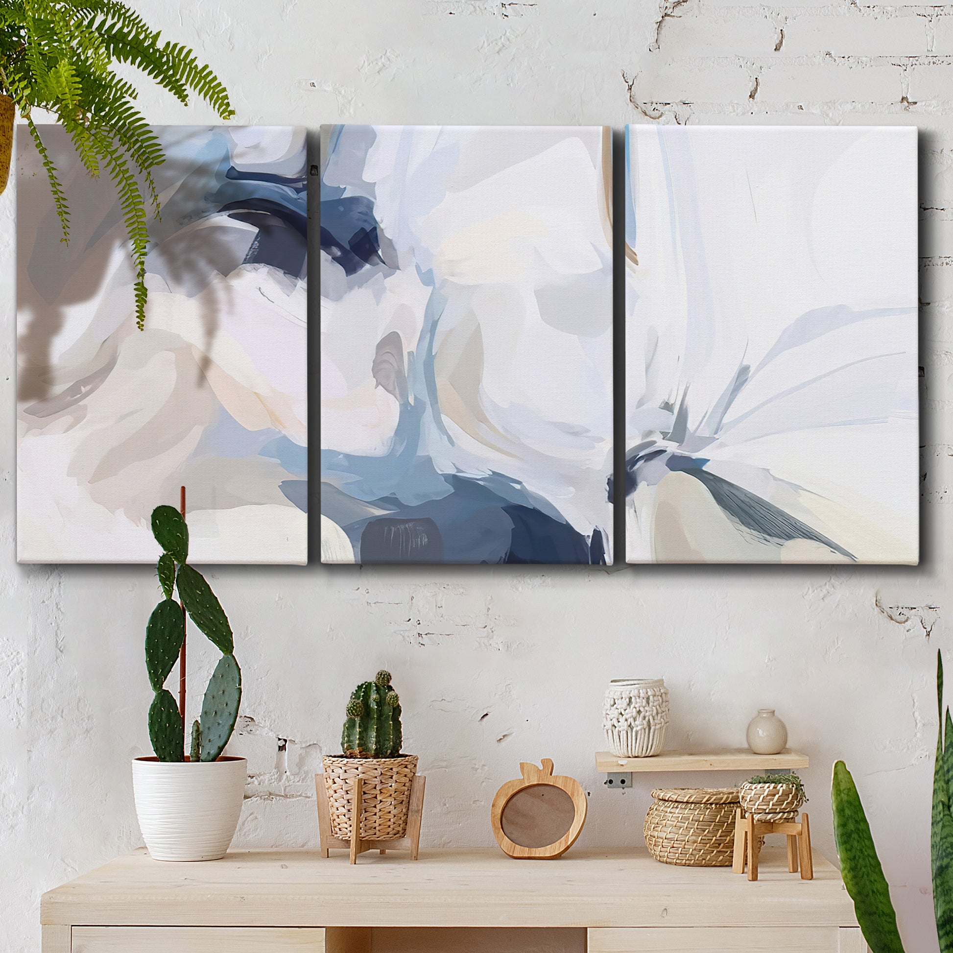 Three-panel canvas wall art featuring airy abstract movement composition, displayed in a boho-chic entryway above a console table.