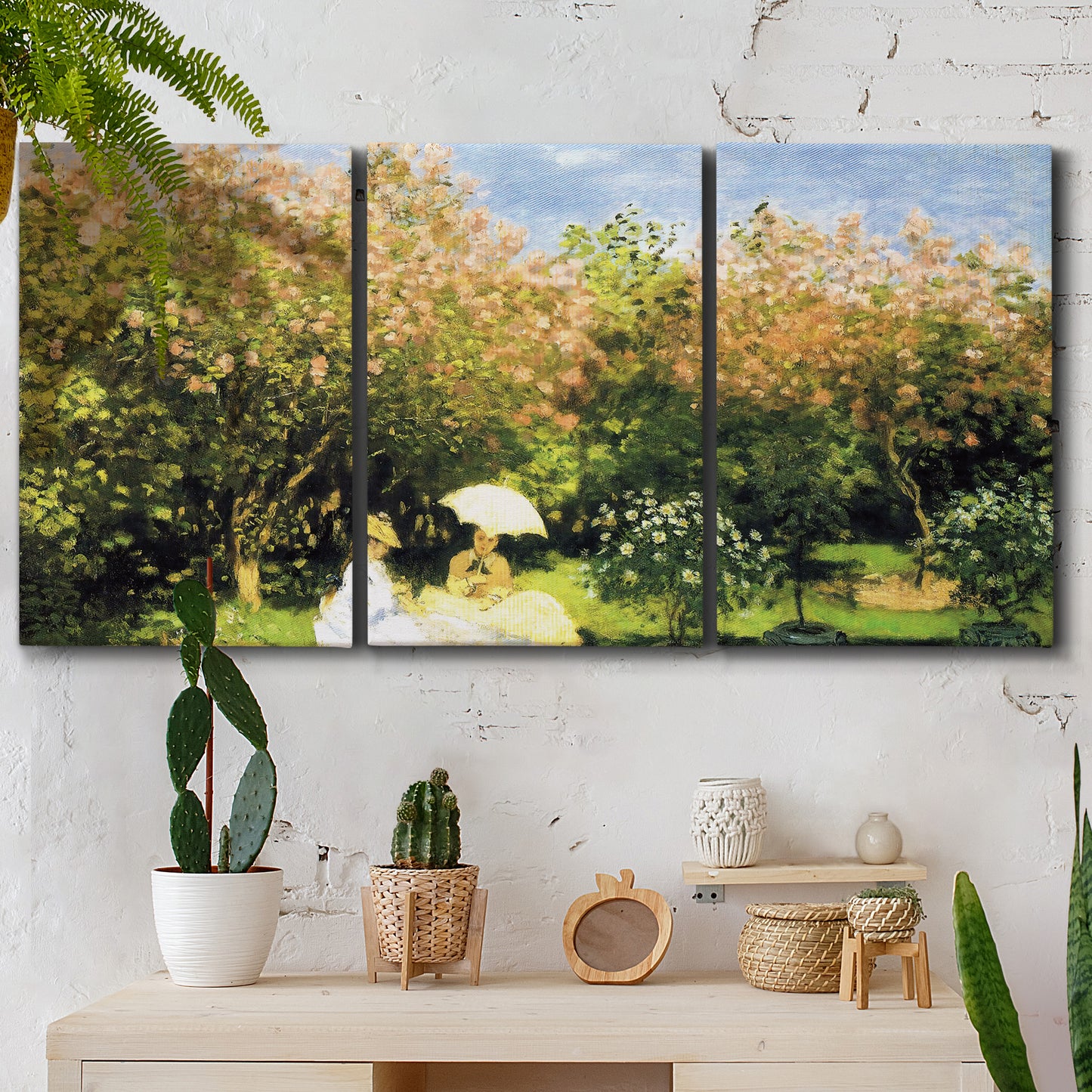 Three-panel canvas wall art featuring lush garden landscape with trees, displayed in a boho-chic entryway above a console table.