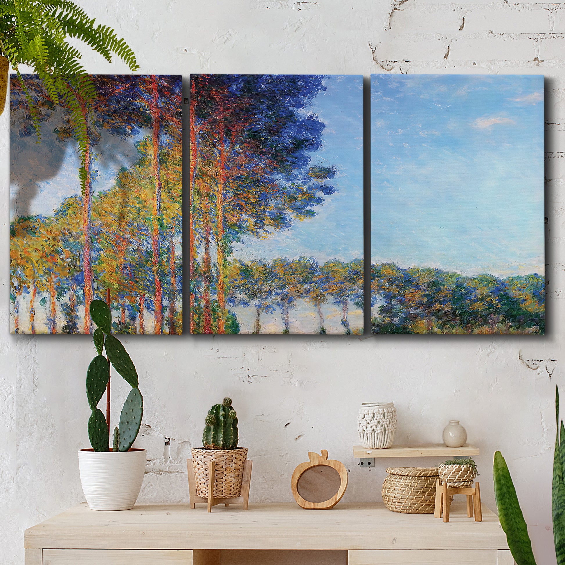 Three-panel canvas wall art featuring autumn poplar trees along river, displayed in a boho-chic entryway above a console table.