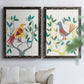 Set of two black barnwood framed canvas prints depicting red yellow blue plumage, simplified leaves, and playful flat shapes arranged across two complementary compositions above a sofa in a bright living space.