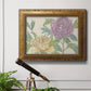 Contemporary peony flower illustration in an ornate vintage gold frame displayed in a light-toned interior setting.