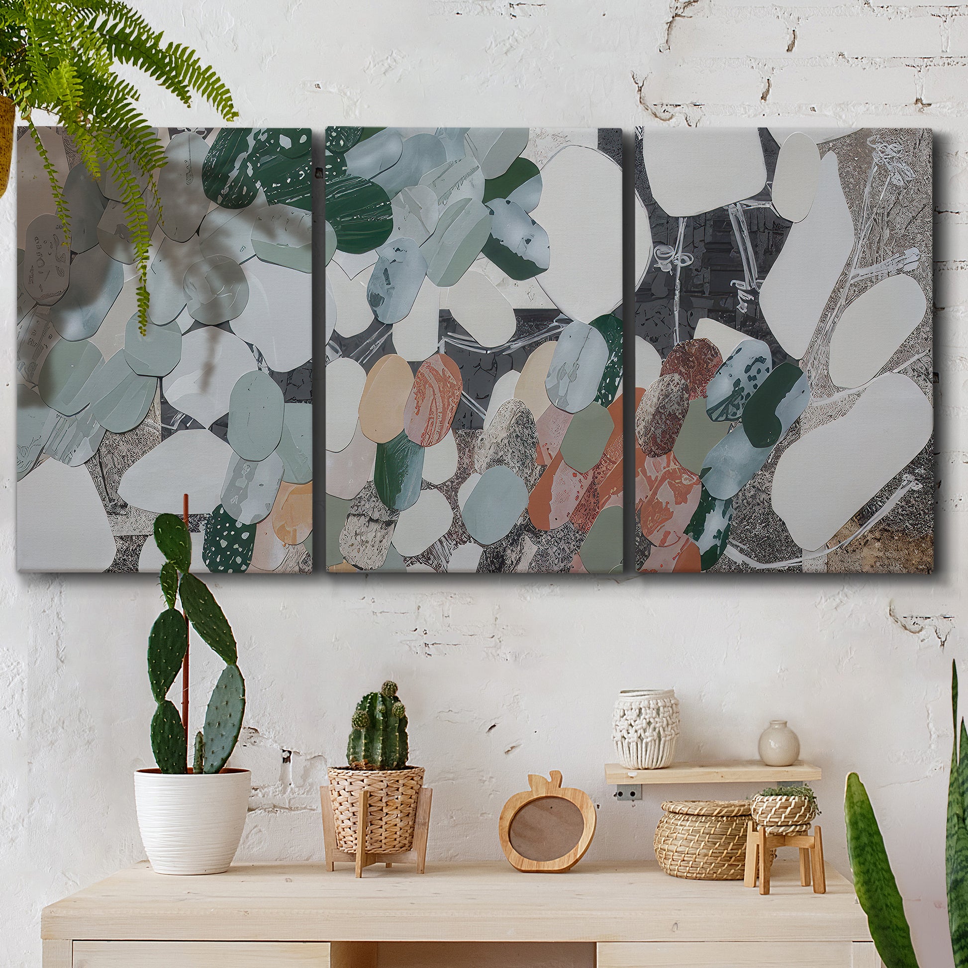 Three-panel canvas wall art featuring layered canyon inspired abstract forms, displayed in a boho-chic entryway above a console table.