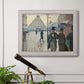 Impressionist urban street scene in the rain by Gustave Caillebotte in an ornate weathered white frame displayed in a light-toned interior setting.