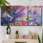 Three-panel canvas wall art featuring expressive abstract with layered color, displayed in a boho-chic entryway above a console table.