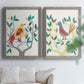 Set of two gray barnwood framed canvas prints depicting red yellow blue plumage, simplified leaves, and playful flat shapes arranged across two complementary compositions above a sofa in a bright living space.