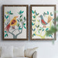 Set of two walnut barnwood framed canvas prints depicting red yellow blue plumage, simplified leaves, and playful flat shapes arranged across two complementary compositions above a sofa in a bright living space.