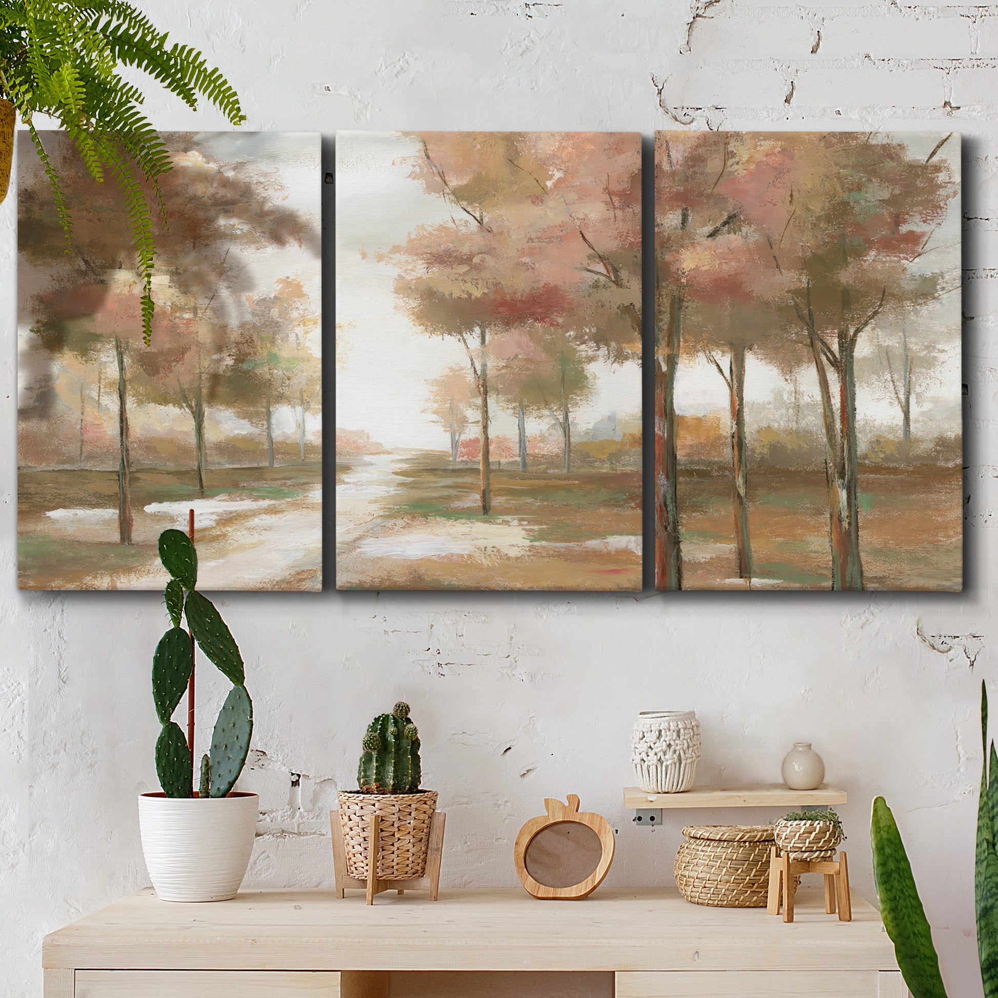 Three-panel canvas wall art featuring soft pastel park landscape scene, displayed in a boho-chic entryway above a console table.