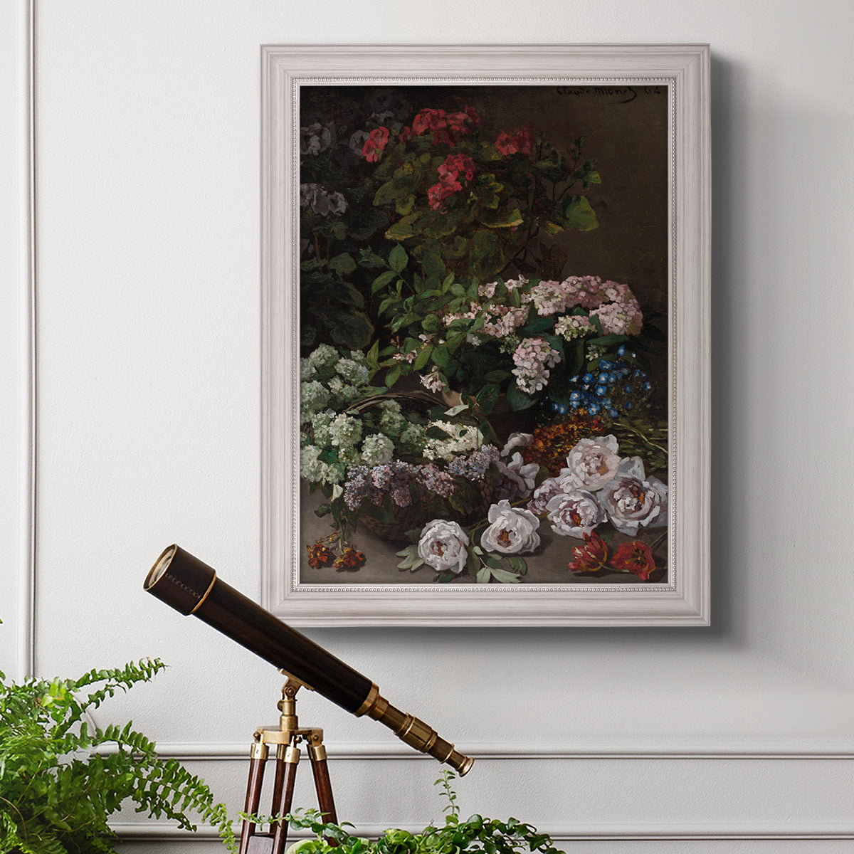 Early impressionist floral painting by Claude Monet in an ornate weathered white frame displayed in a light-toned interior setting.