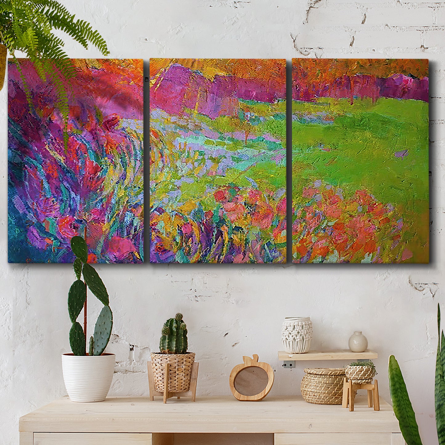 Three-panel canvas wall art featuring abstract meadow inspired color fields, displayed in a boho-chic entryway above a console table.