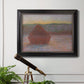 Impressionist haystack sunset scene in winter by Claude Monet in an ornate black frame with gilded inner detail displayed in a light-toned interior setting.