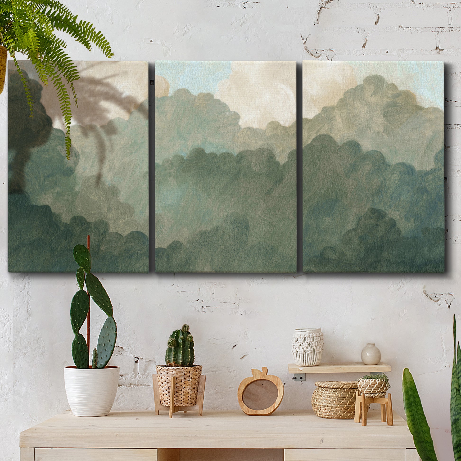 Three-panel canvas wall art featuring autumn storm over rolling landscape, displayed in a boho-chic entryway above a console table.