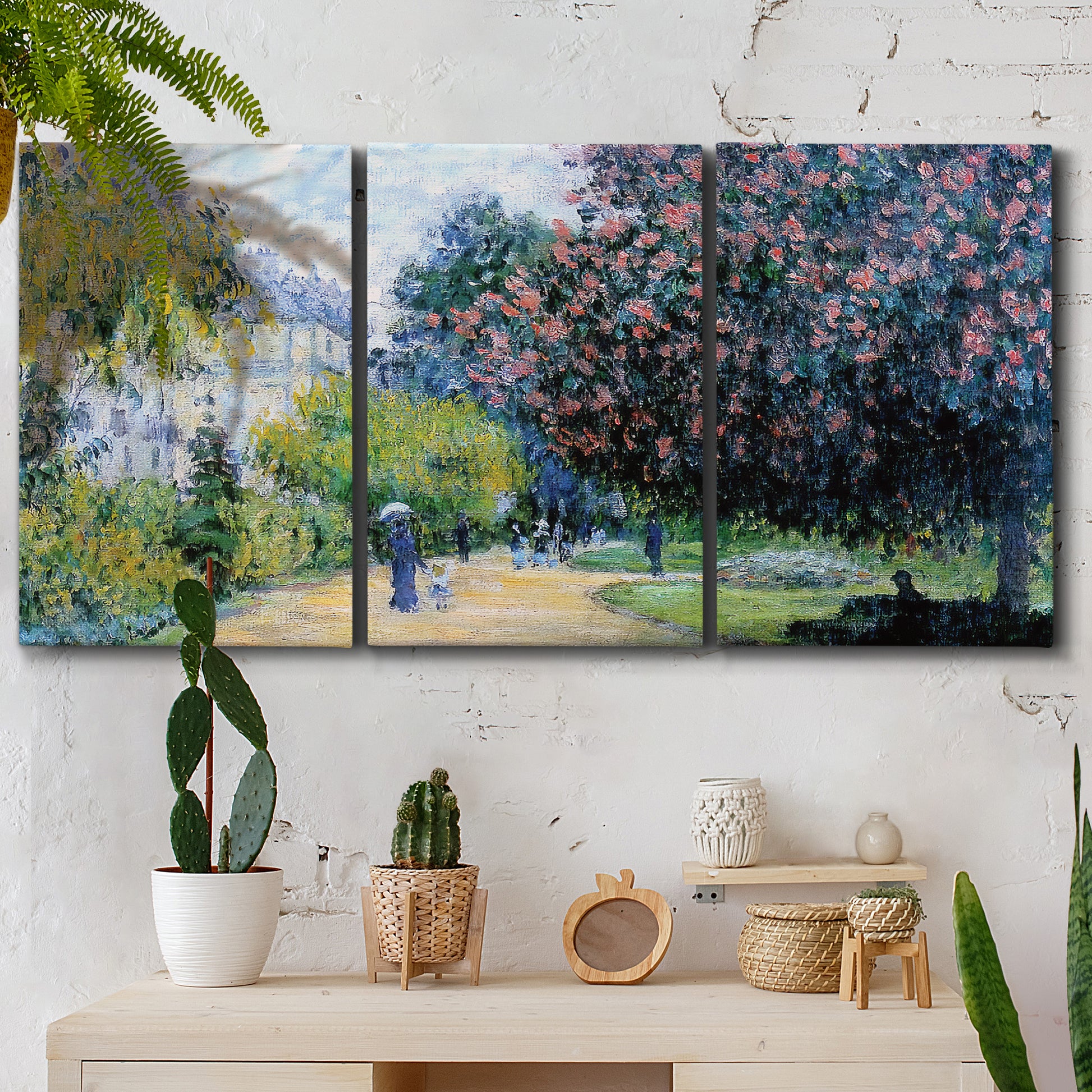 Three-panel canvas wall art featuring formal city park with trees, displayed in a boho-chic entryway above a console table.