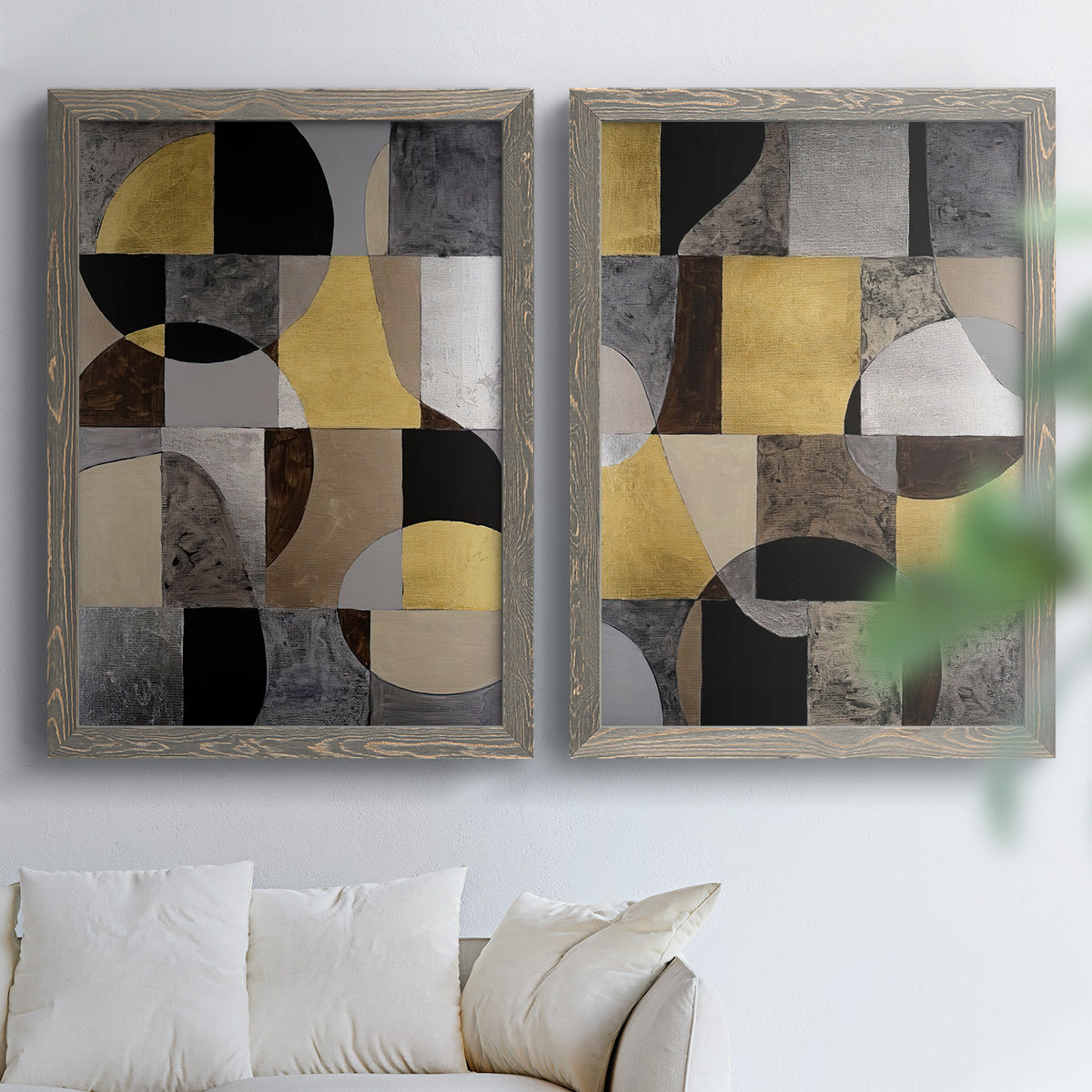 Set of two gray barnwood framed canvas prints depicting semicircles, rectangles, textured panels, and metallic-looking accents arranged across two complementary compositions above a sofa in a bright living space.