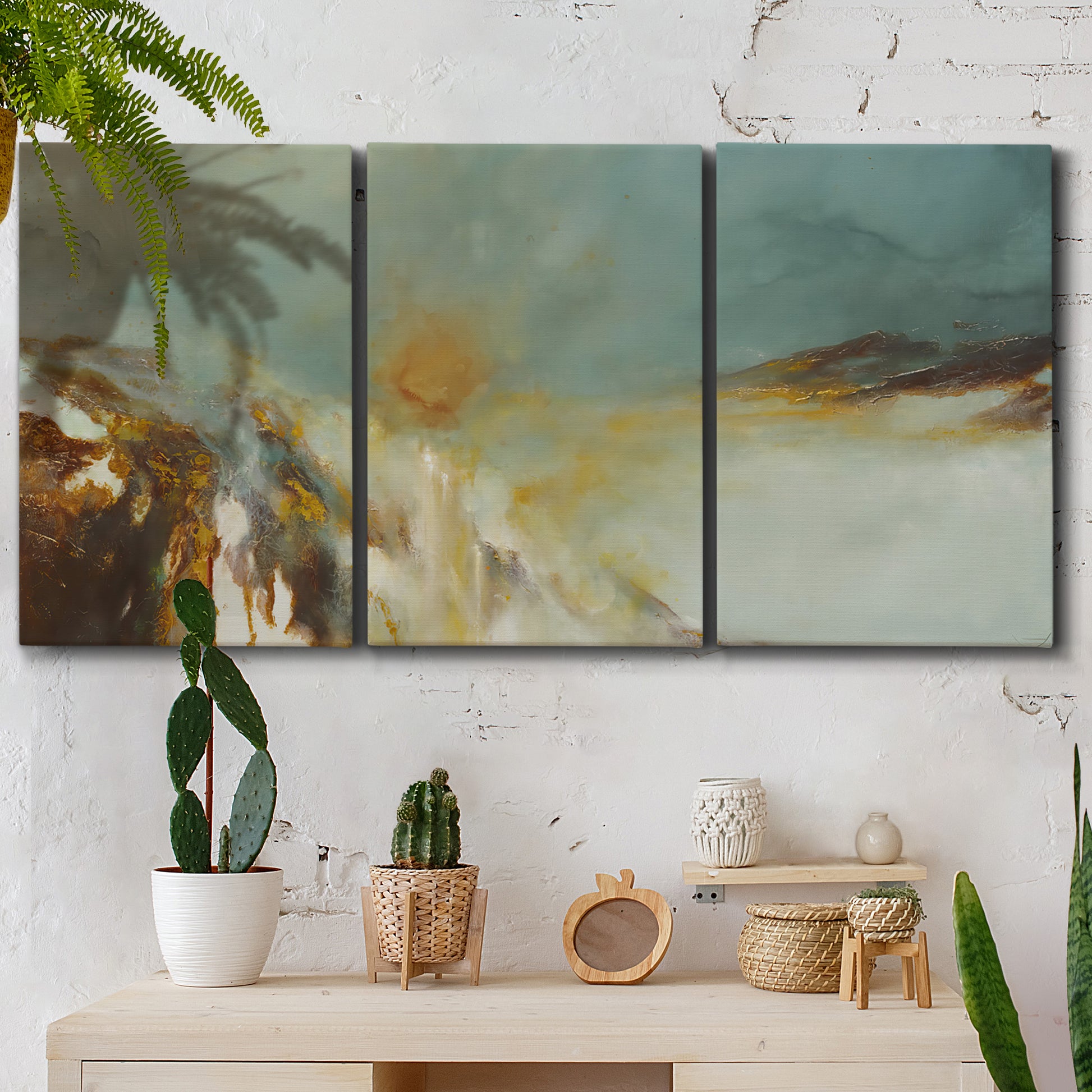 Three-panel canvas wall art featuring earth toned abstract solar landscape, displayed in a boho-chic entryway above a console table.
