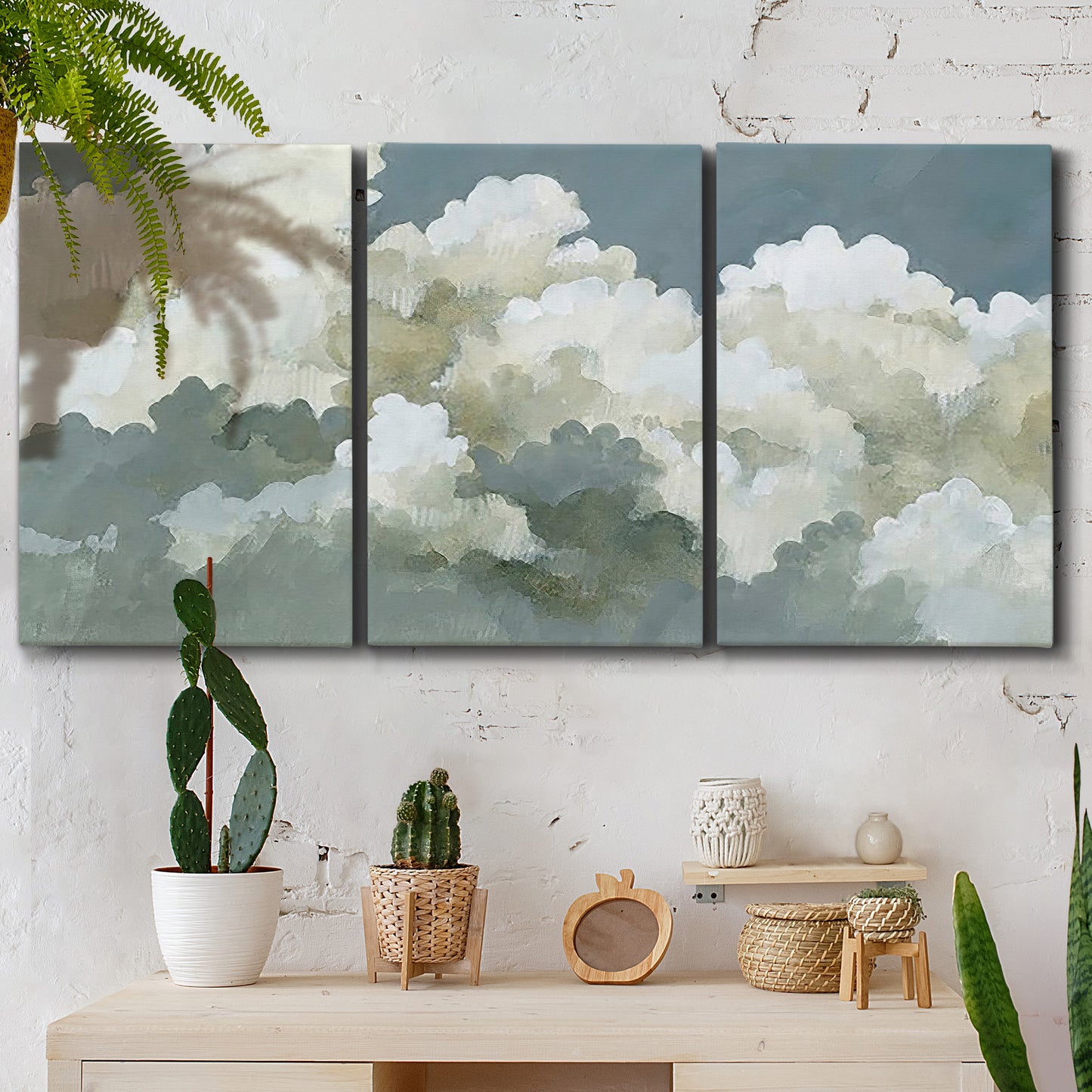 Three-panel canvas wall art featuring abstract evening landscape with depth, displayed in a boho-chic entryway above a console table.