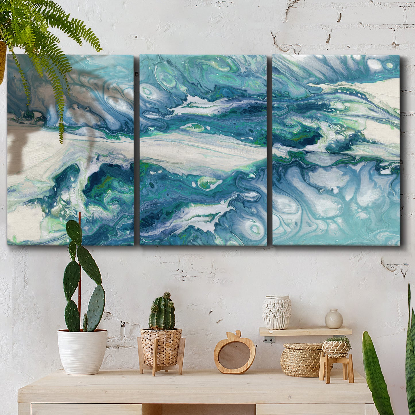 Three-panel canvas wall art featuring layered abstract marble textures, displayed in a boho-chic entryway above a console table.