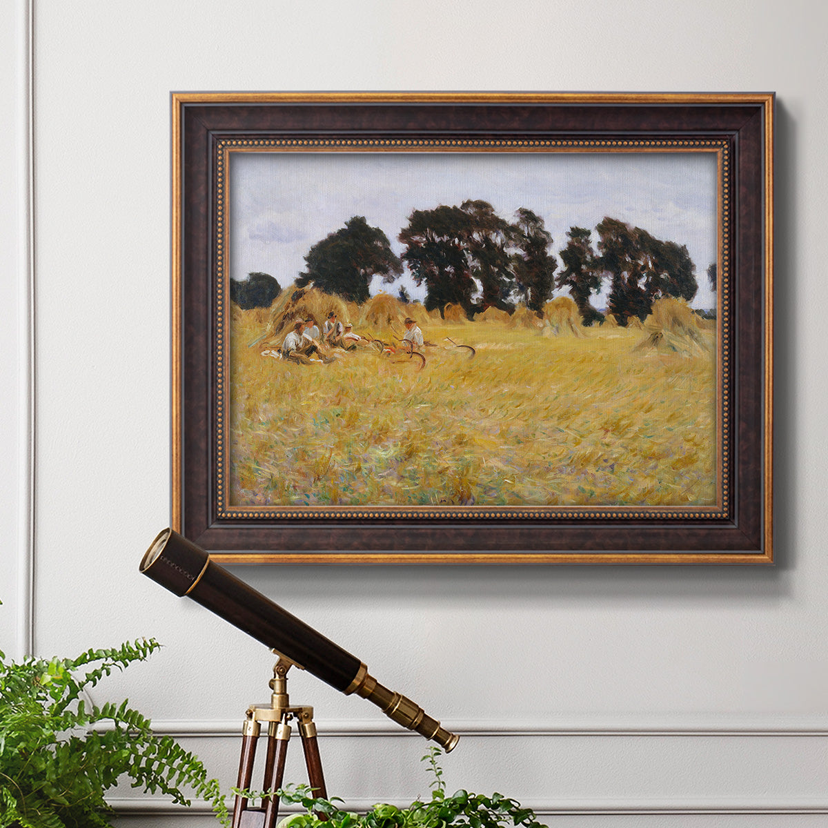 Impressionist rural harvest scene by John Singer Sargent in an ornate bronzed mahogany wood frame displayed in a light-toned interior setting.