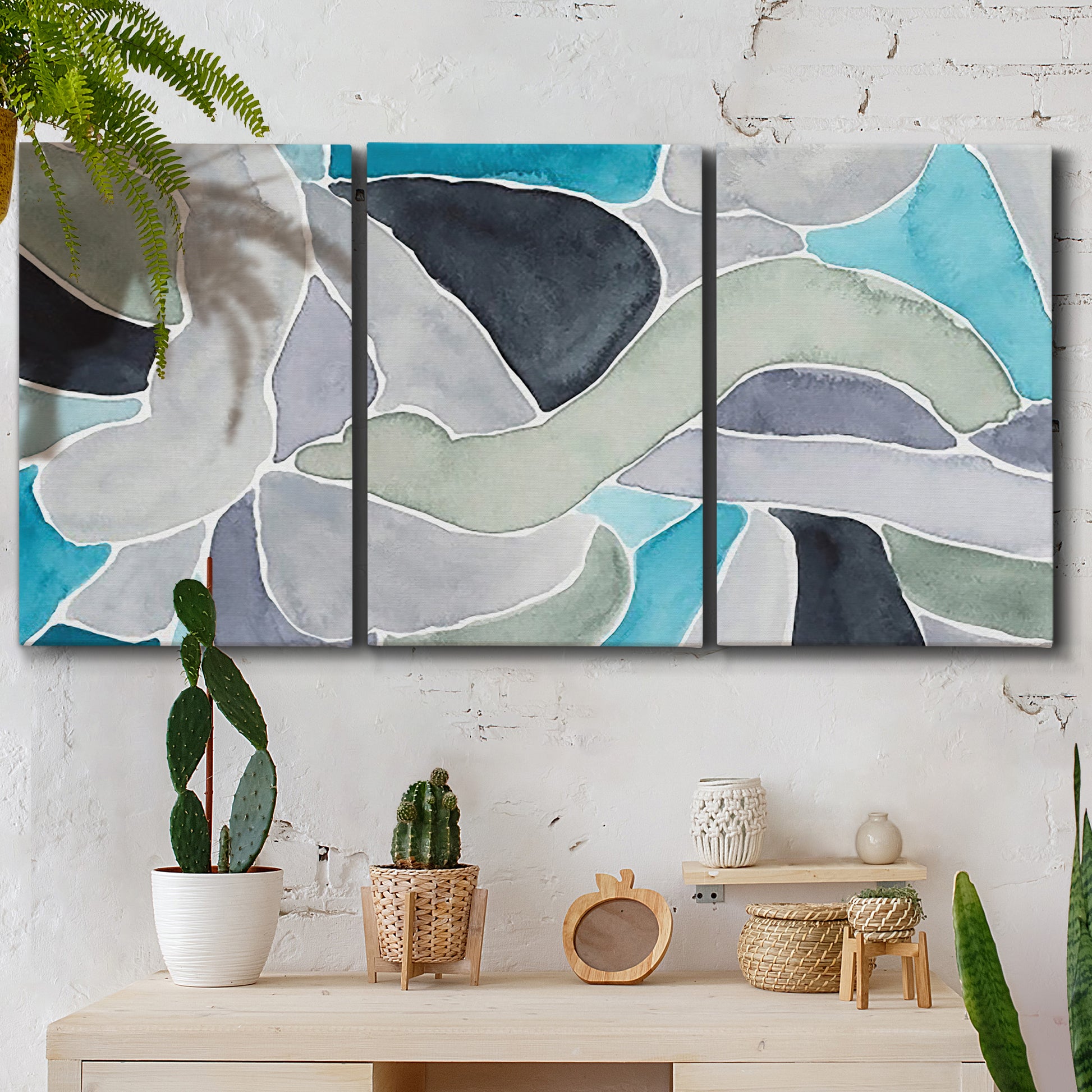 Three-panel canvas wall art featuring subtle abstract billowing color layers, displayed in a boho-chic entryway above a console table.