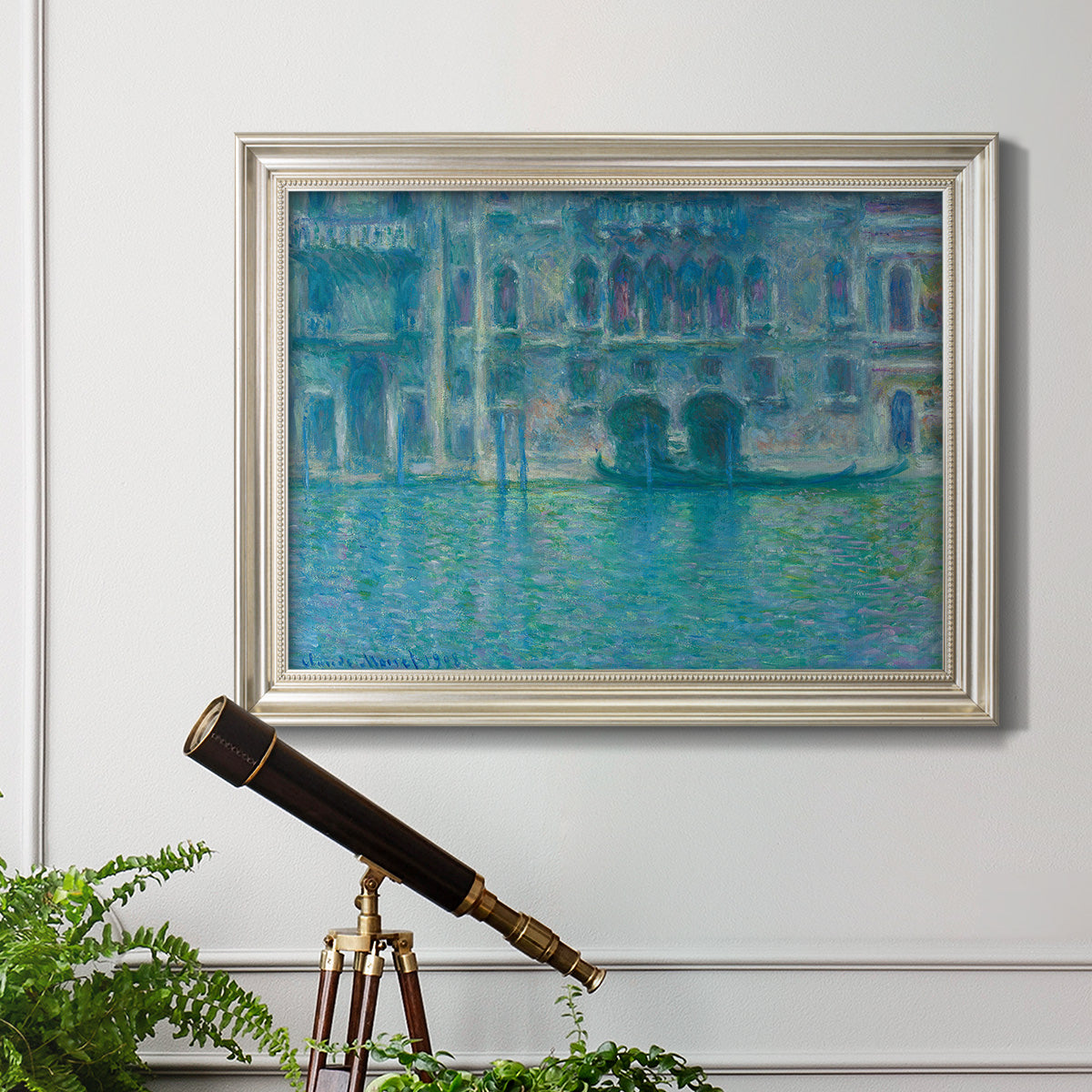 Impressionist Venetian palace waterfront scene by Claude Monet in an ornate champagne frame displayed in a light-toned interior setting.