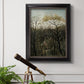 Dreamlike forest landscape scene by Henri Rousseau in an ornate black frame with gilded inner detail displayed in a light-toned interior setting.