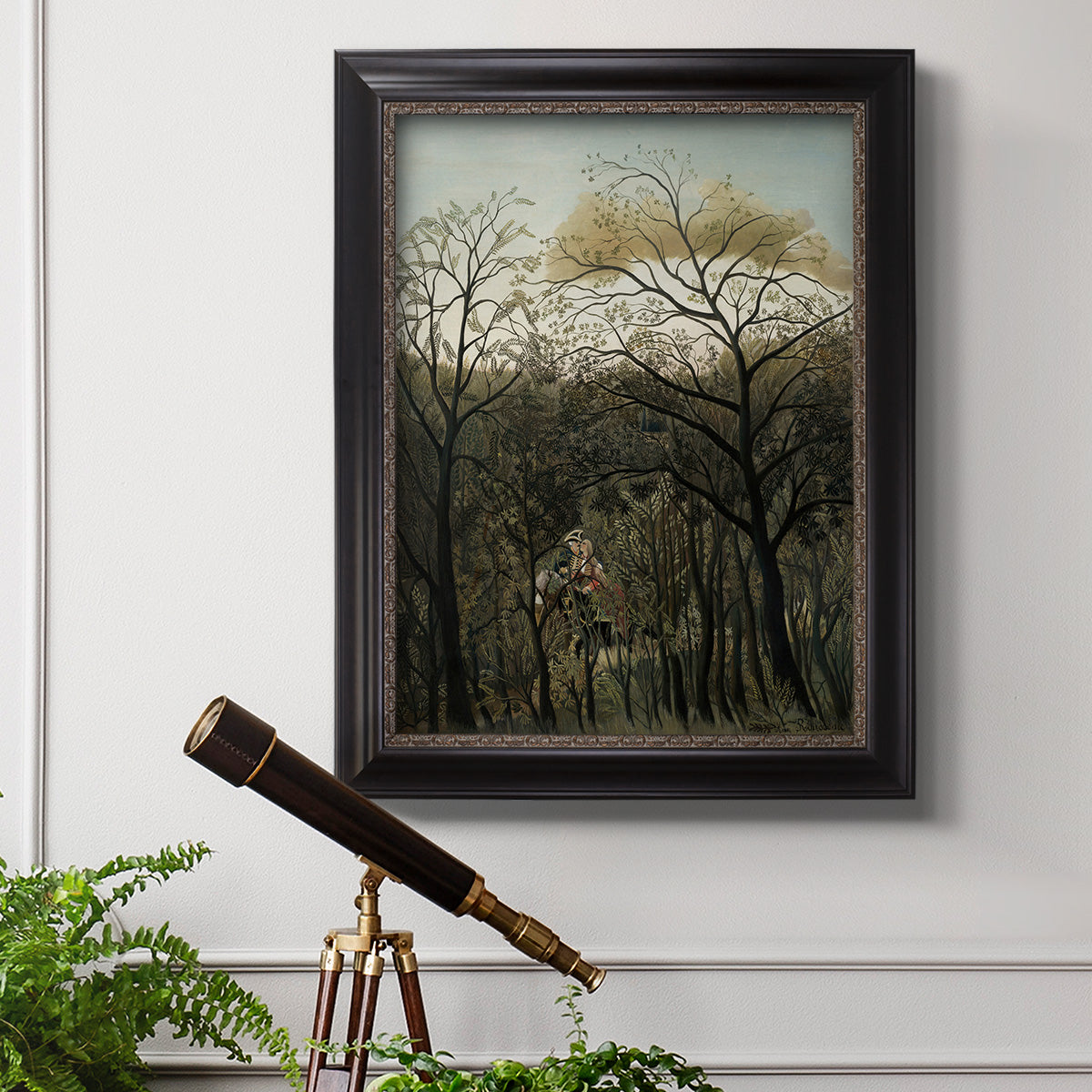 Dreamlike forest landscape scene by Henri Rousseau in an ornate black frame with gilded inner detail displayed in a light-toned interior setting.