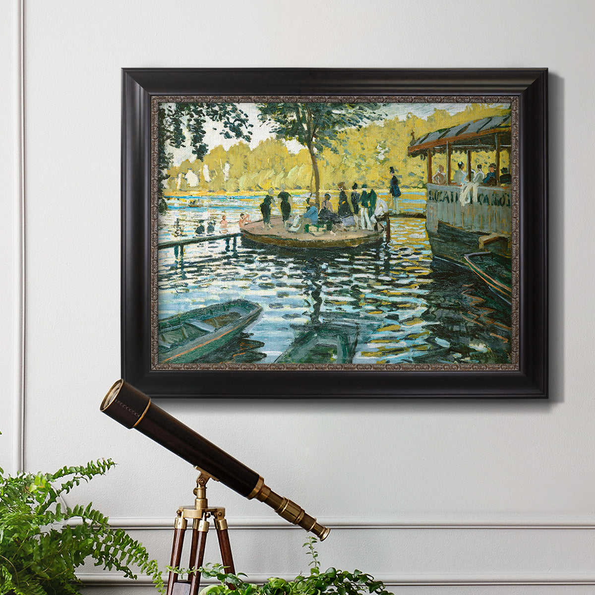 Impressionist riverside leisure scene by Claude Monet in an ornate black frame with gilded inner detail displayed in a light-toned interior setting.