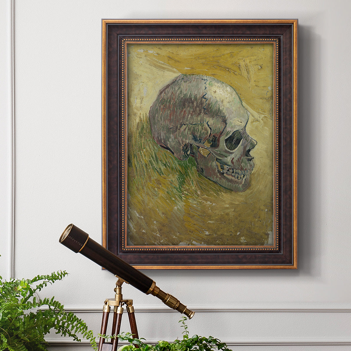 Profile skull study artwork by Vincent van Gogh in an ornate bronzed mahogany wood frame displayed in a light-toned interior setting.